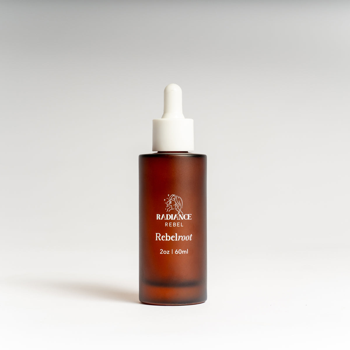 Brown bottle with dropper labeled 'Radiance Rebel Rebelroot' on a white background