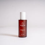 A bottle of RADIANCE REBEL RebelCleanse Dry cleanser, featuring a translucent amber-brown bottle and a white cap, set against a plain light gray background.